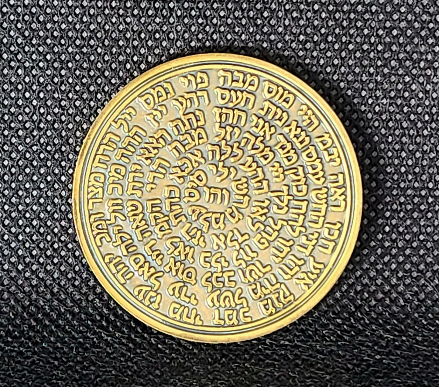 Third Pentacle of Saturn talisman coin held in hand, solid brass engraved seal