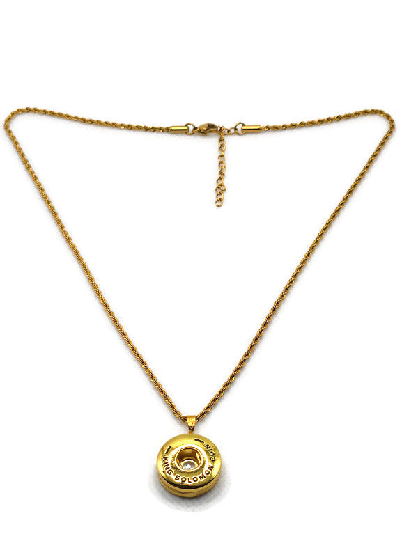 Gold necklace with a round pendant on a white background