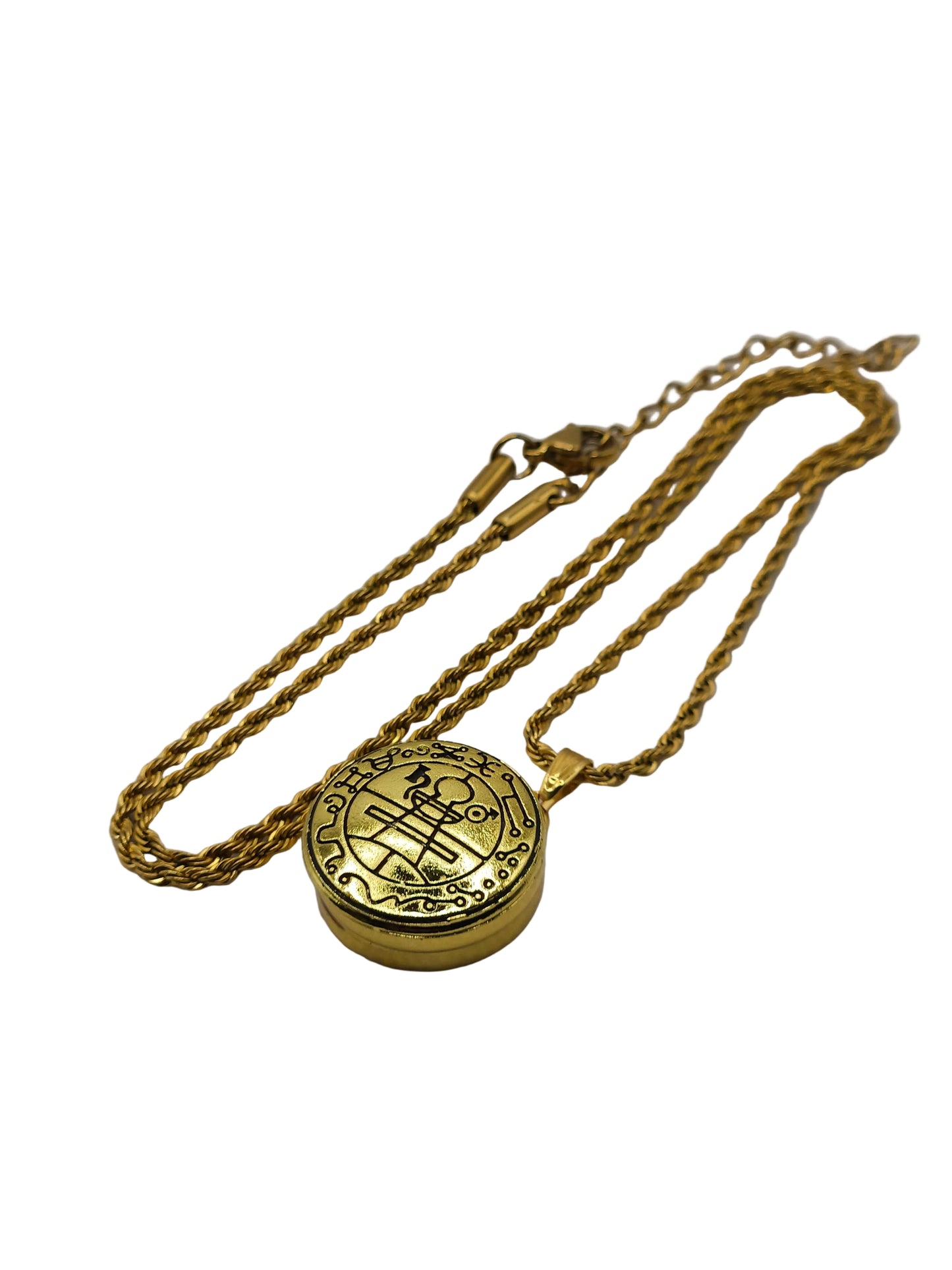 Gold necklace with a round pendant on a gray background