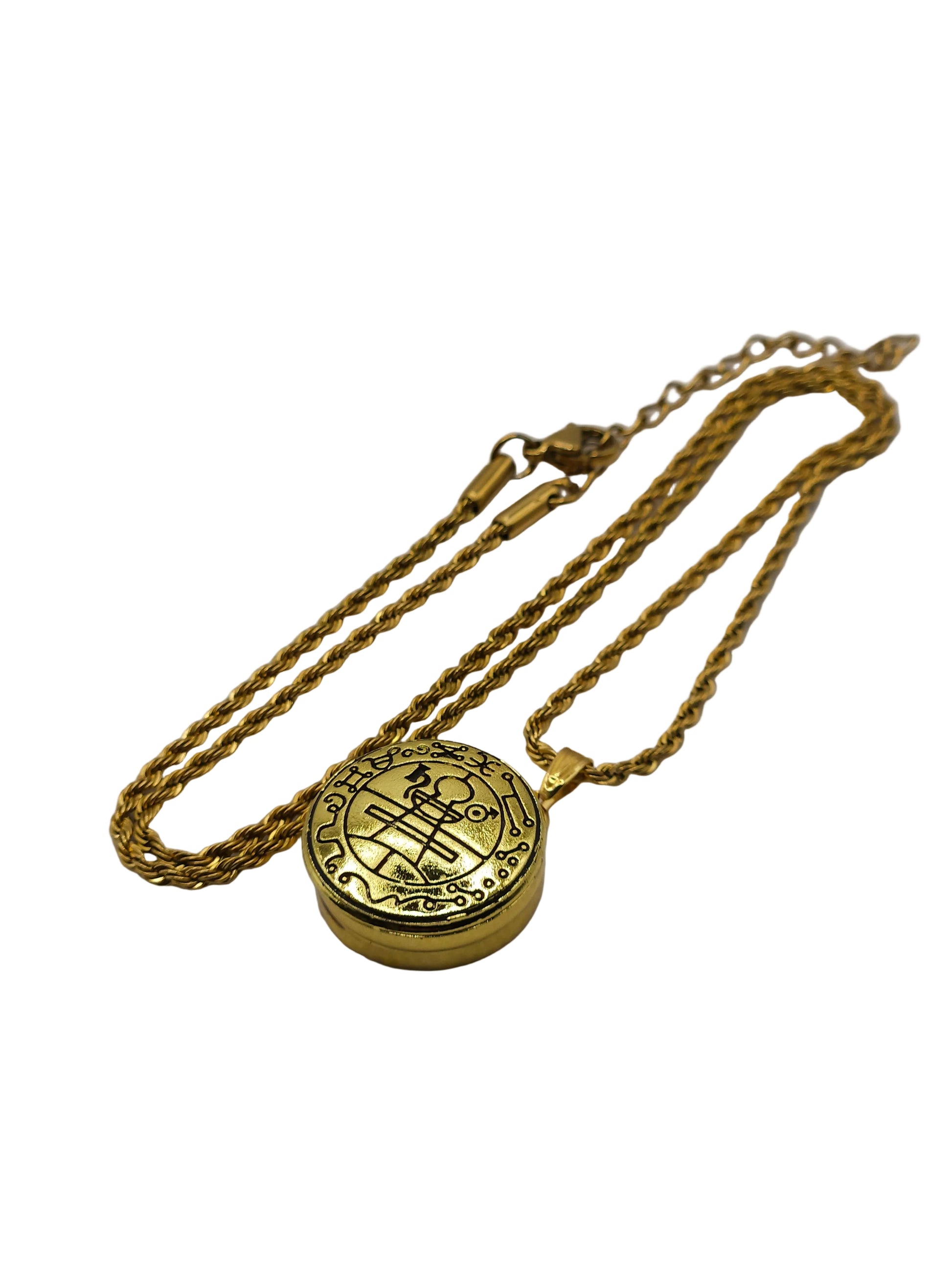 Gold necklace with a round pendant on a gray background
