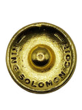 Gold-colored button with 'Dedion Solomons' branding on a gray background