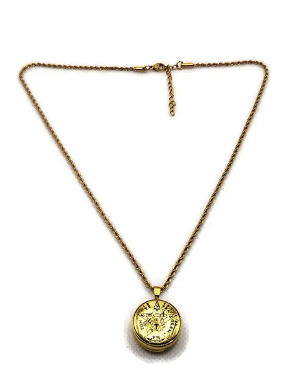 Gold necklace with a round pendant on a white background